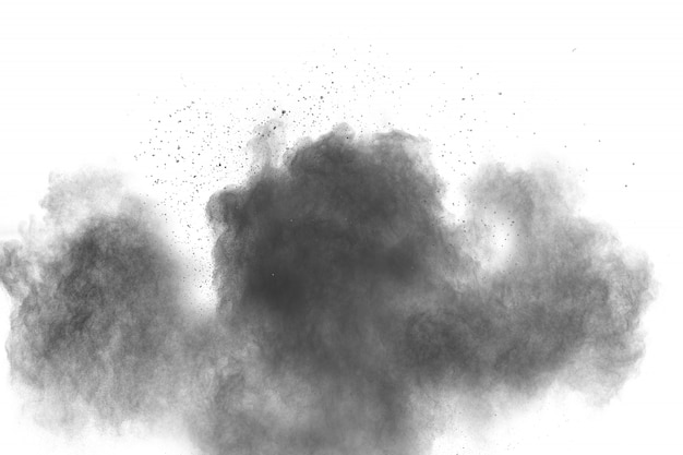 Photo black powder explosion on white background. black dust particles splash.