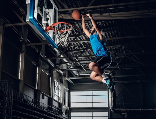 Black professional Black basketball player in action in a basketball court.