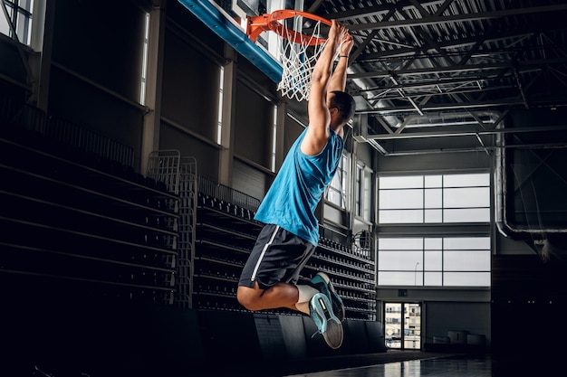 Black professional Black basketball player in action in a basketball court.