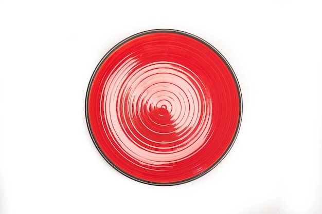 A black and red ceramic round dish on a white background with copy space in a top view