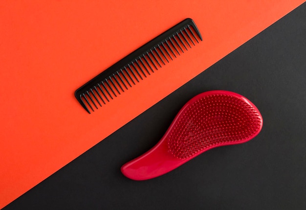 Black and red combs on the colored backgroundTop view Closeup Copy space