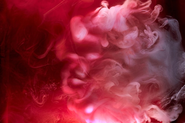 Black and red ink background colorful fog abstract swirling ocean acrylic paint pigment underwater white smoke