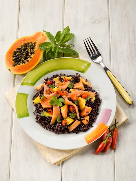 Black rice with papaya and smoked salmon