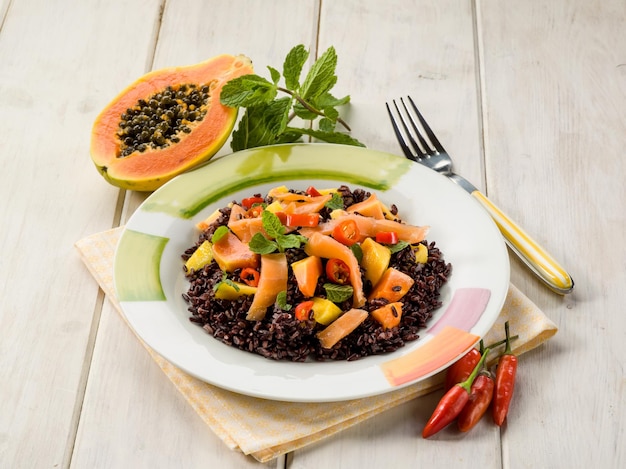 Black rice with papaya and smoked salmon