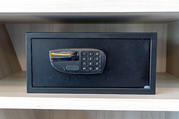 Black safe box stroungbox in the wood pattern shelf in resort bedroom