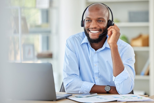 Black sales man call center agent and customer service support advice consulting and talking conversation loan in office African young and happy consultant crm telemarketing and contact us work