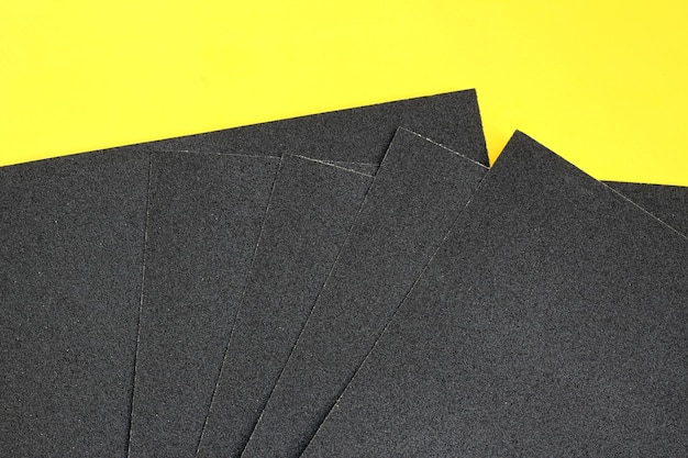 Photo black sandpaper on yellow background