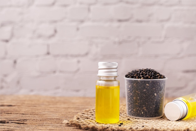 Black sesame oil on wooden table.