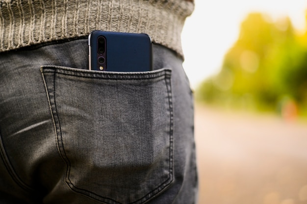 Photo black smartphone in the back pocket of jeans