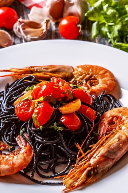 Black spaghetti with prawns and tomato