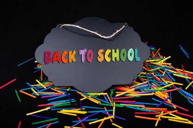 Black speech bubble shaped notice board on colorful sticks