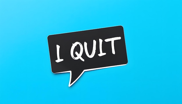 Black speech bubble sticker on blue copy space background with handwritten text I QUIT concept of