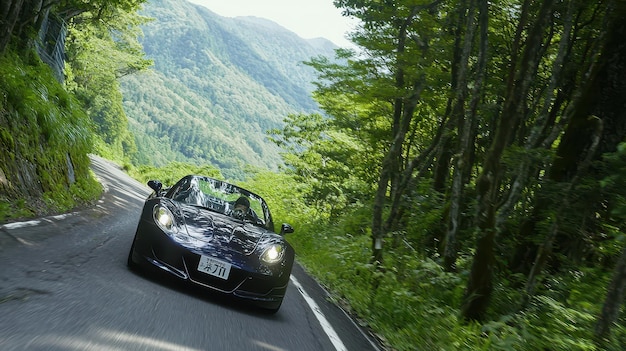 Photo black sports car driving on winding road through lush green forest