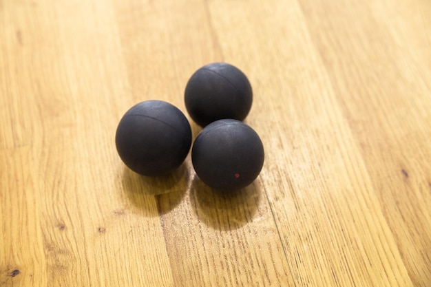 Black squash balls in squash court in tennis club