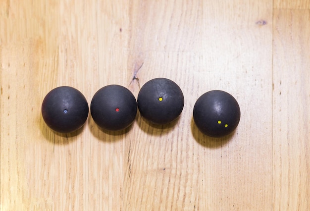 Black squash balls in squash court in tennis club