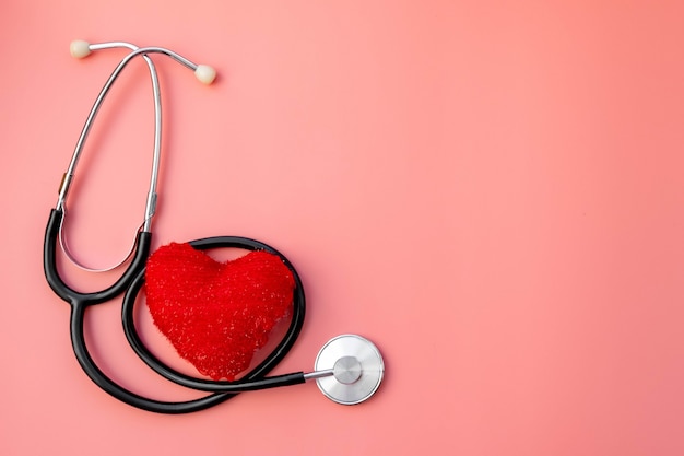 Black stethoscope with red heart of doctor for checkup. Stethoscope equipment of medical use. Health care and cardiology concept with copy space. Valentines day