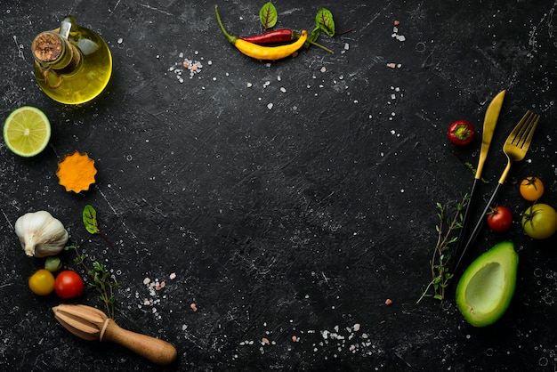 Black stone background with vegetables and spicesTop view Rustic style