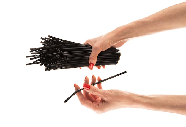 Black straws in hands isolated on white background