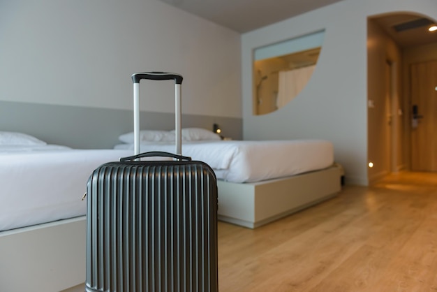 A black suitcase lies on the floor in a luxury hotel bedroom with two single bed In the bag were clothes and personal items prepared for the weekend