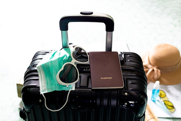 black suitcase and passport,Suitcase, passport and medical mask,luggage,background ,sunglasses,Face