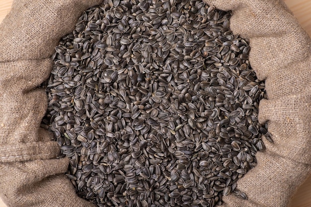 Black sunflower seeds in linen sack