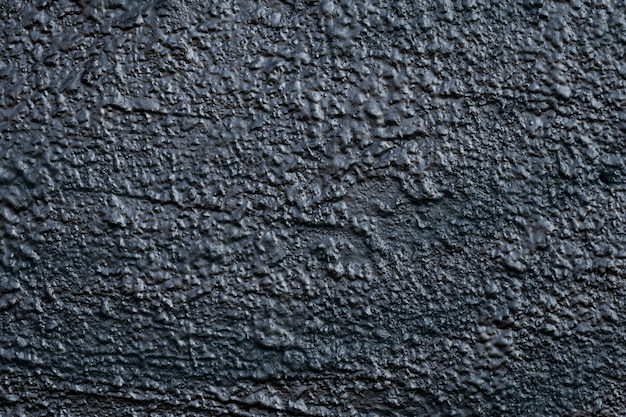 Black surface of concrete wall. Dark rough texture. Grunge background.