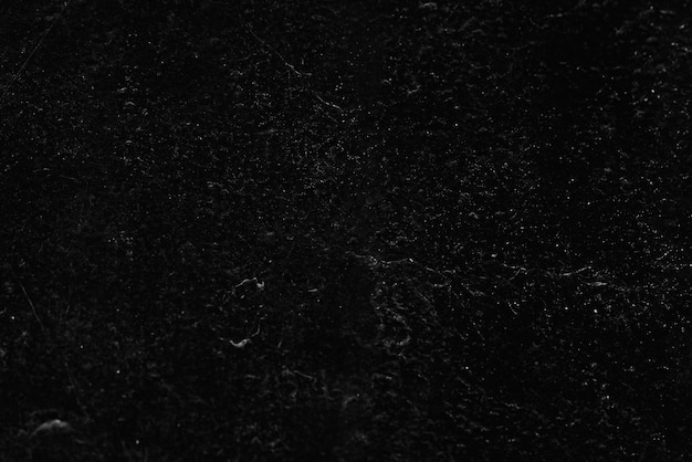 Photo a black surface with a white textured background