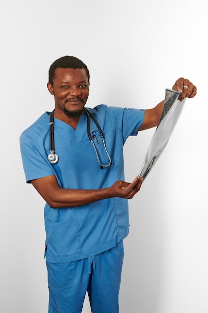 Black surgeon doctor bearded man in blue coat with crossed arms isolated white background copy space