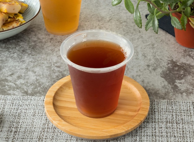 Black tea served in disposable cup isolated on napkin top view on table taiwan food