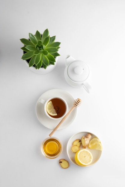 Black tea with lemon and honey on a white background