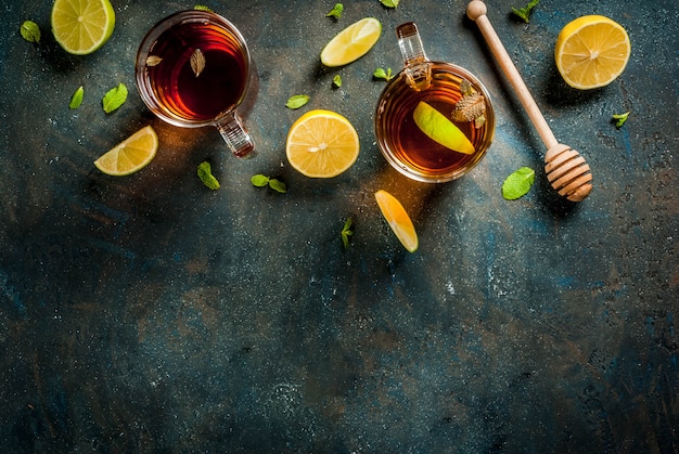 Black tea with lemon and mint on dark blue concrete stone , copyspace top view