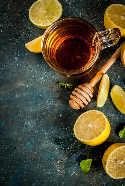 Black tea with lemon and mint on dark blue concrete stone , copyspace top view