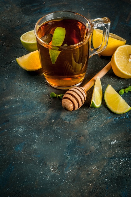 Black tea with lemon and mint on dark blue concrete stone , copyspace