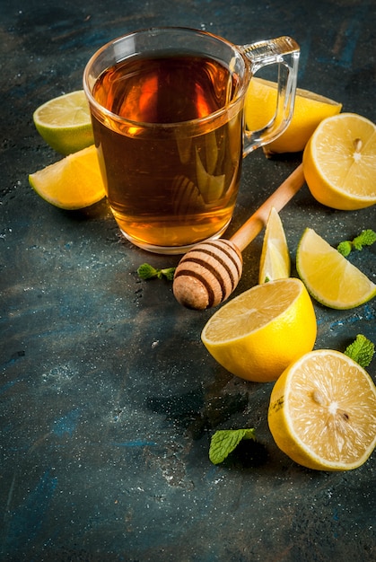 Black tea with lemon and mint on dark blue concrete stone , copyspace