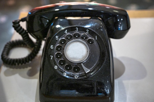 A black telephone with the number 6 on it