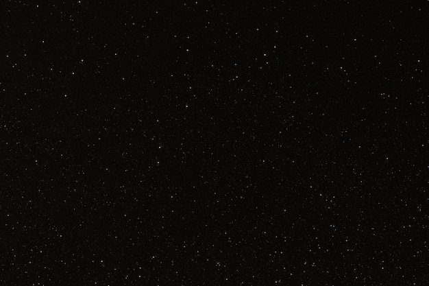 Photo black texture with micro-relief and glitter similar to the night sky with stars