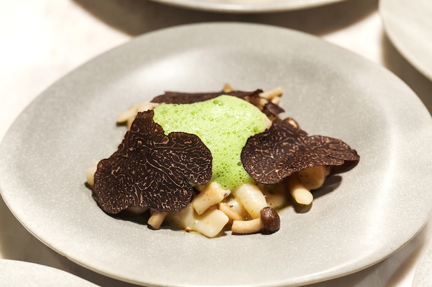 Black truffles on gray plate close up