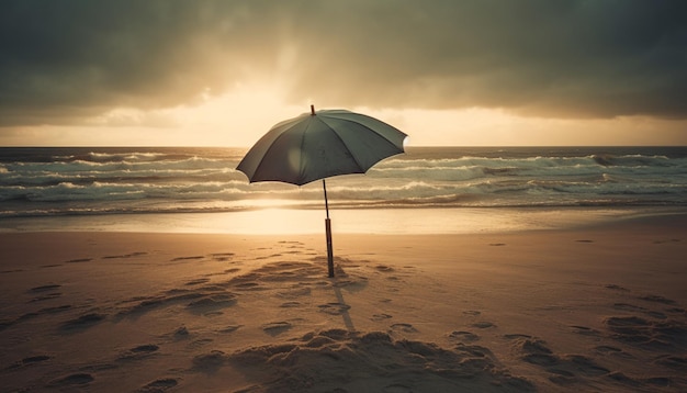 A black umbrella stands on a beach in front of the ocean.