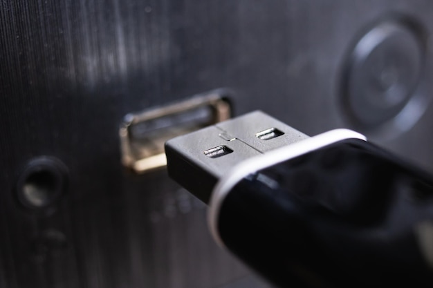 Black USB flashcard and laptop close up