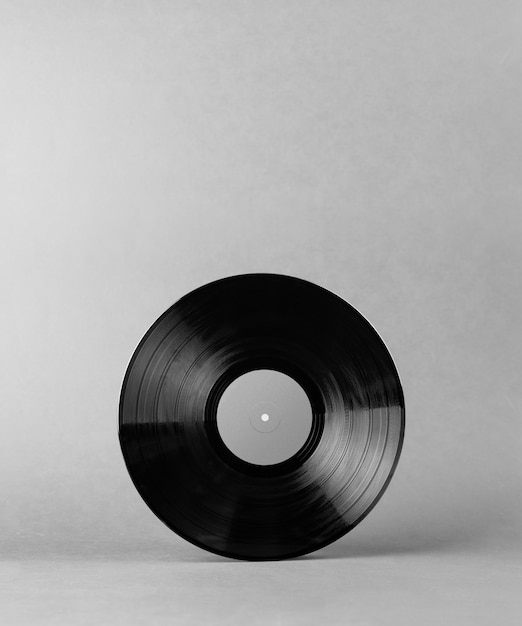 Black vinyl music record isolated on abstract gray background