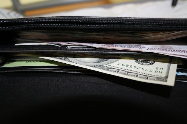 Black wallet money with cash dollars