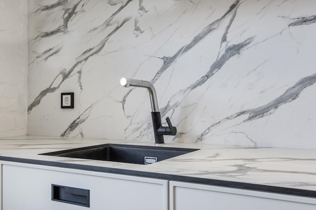 Black water tap sink with faucet in expensive kitchen