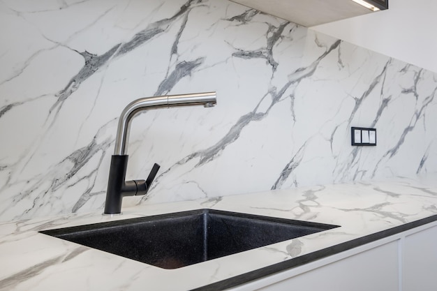 Black water tap sink with faucet in expensive kitchen