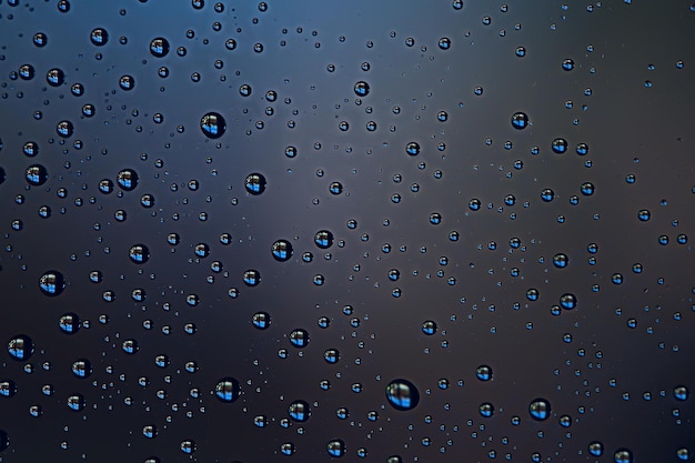 black wet background / raindrops for overlaying on window, concept of autumn weather, background of drops of water rain on glass transparent