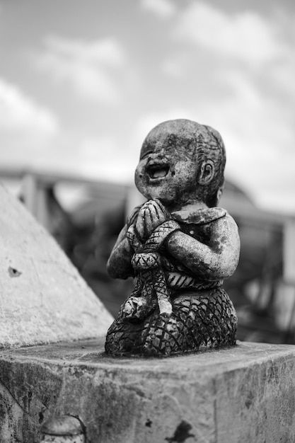 Black and white broken stone smile and happy kid statue