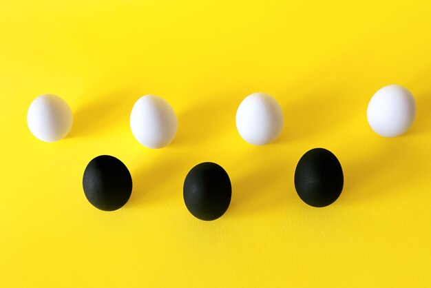 Black and white eggs on the yellow background