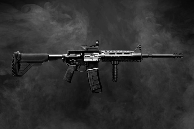 A black and white image of an assault rifle with the word rifle on it.