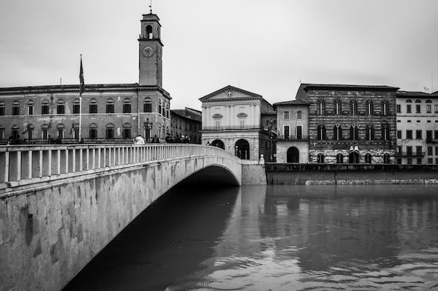 Black and white image of Ponte di Mezzo bridge in Pisa over Arno river Tuscany, Italy