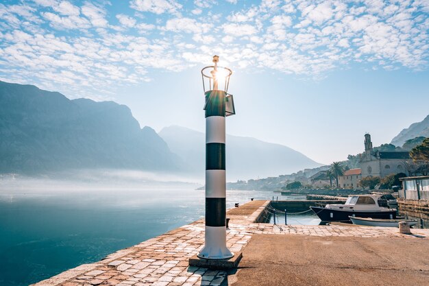 Black and white lighthouse in the sea prcanj kotor bay monten