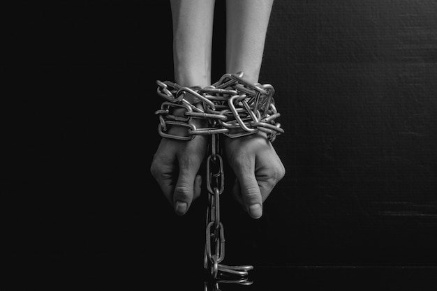 Black and white minimalistic women hands chained close-up 